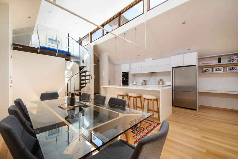 Dining zone with the kitchen and spiral staircase beyond